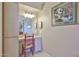 Well-lit vanity area with a large mirror and a chair at 10648 W Loma Blanca Dr, Sun City, AZ 85351