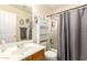 Cozy bathroom with a combination shower and tub, storage shelves and mirror at 13022 W Cherry Hills Dr, El Mirage, AZ 85335
