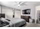 Calming bedroom featuring neutral tones, dual closets, and a mounted television at 13022 W Cherry Hills Dr, El Mirage, AZ 85335