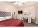Inviting bedroom featuring a comfortable bed, vanity area and a chest of drawers at 13022 W Cherry Hills Dr, El Mirage, AZ 85335