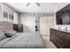 Serene bedroom with neutral tones, dual closets, and abundant natural light from the window at 13022 W Cherry Hills Dr, El Mirage, AZ 85335