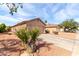 Southwest home with a low-maintenance gravel yard and mature desert landscaping at 13022 W Cherry Hills Dr, El Mirage, AZ 85335