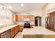 Well-lit kitchen featuring wooden cabinets, stainless steel appliances, and a functional layout at 13022 W Cherry Hills Dr, El Mirage, AZ 85335