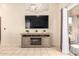 Cozy living room with entertainment center and sliding glass door to the backyard at 13022 W Cherry Hills Dr, El Mirage, AZ 85335