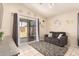 Cozy living room with a sofa, sliding glass door, and neutral decor at 13022 W Cherry Hills Dr, El Mirage, AZ 85335