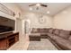 Cozy living room with neutral colors, a ceiling fan, and comfortable seating area at 13022 W Cherry Hills Dr, El Mirage, AZ 85335