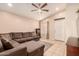 Comfortable living room with a sectional sofa, ceiling fan, and views of the entryway at 13022 W Cherry Hills Dr, El Mirage, AZ 85335
