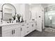 Modern bathroom with double vanity, sleek fixtures, and a glass-enclosed shower at 1304 W Ocotillo Rd, Phoenix, AZ 85013