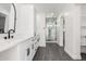 Spacious bathroom featuring double vanities, a glass enclosed shower, and neutral gray floor tile at 1304 W Ocotillo Rd, Phoenix, AZ 85013