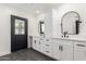 Bright bathroom with modern white cabinets, black hardware, and striking black framed mirrors at 1304 W Ocotillo Rd, Phoenix, AZ 85013