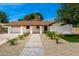 Charming single-story home with desert landscaping, brick pathway, and white pillars at 1304 W Ocotillo Rd, Phoenix, AZ 85013