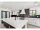 Spacious kitchen featuring a center island, white cabinets, and modern lighting fixtures at 1304 W Ocotillo Rd, Phoenix, AZ 85013