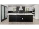 Modern kitchen with a large island, black accents, and stainless steel appliances at 1304 W Ocotillo Rd, Phoenix, AZ 85013