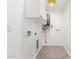Bright laundry room with tiled floors, white cabinetry, and utility connections ready for appliances at 1304 W Ocotillo Rd, Phoenix, AZ 85013