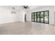 Bright living space with tiled floors, large windows, and access to the backyard at 1304 W Ocotillo Rd, Phoenix, AZ 85013