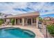 Inviting backyard pool with stone surround and covered patio, perfect for outdoor relaxation and entertaining at 15809 S 31St St, Phoenix, AZ 85048