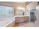 Bright bathroom with a large soaking tub, double vanity, and stylish tile flooring at 15809 S 31St St, Phoenix, AZ 85048