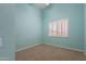 Cozy bedroom has blue walls, neutral carpet, and a window with white blinds at 15809 S 31St St, Phoenix, AZ 85048