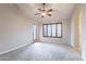 Spacious bedroom with plush carpeting, ceiling fan, and shuttered windows at 15809 S 31St St, Phoenix, AZ 85048