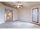 Carpeted bedroom featuring a ceiling fan and access to the kitchen at 15809 S 31St St, Phoenix, AZ 85048