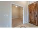 Foyer leading to a bedroom with a ceiling fan with carpet and a solid wood front door at 15809 S 31St St, Phoenix, AZ 85048