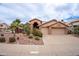 Inviting single-story home with a well-manicured front yard, desert landscaping, and a two-car garage at 15809 S 31St St, Phoenix, AZ 85048