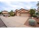 Charming single-story home featuring a three-car garage, desert landscaping, and neutral color palette at 15809 S 31St St, Phoenix, AZ 85048