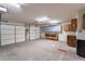 Two car garage provides storage, shelving, and work benches at 15809 S 31St St, Phoenix, AZ 85048
