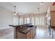 Open kitchen with island, granite countertops, and stainless steel sink at 15809 S 31St St, Phoenix, AZ 85048
