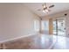Bright living room features tile floors, ceiling fan, and sliding glass doors leading to the backyard at 15809 S 31St St, Phoenix, AZ 85048