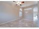 Bright living room showcasing neutral paint, tile floors, arched windows, and elegant lighting at 15809 S 31St St, Phoenix, AZ 85048