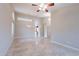 Open-concept living room with tile flooring, high ceilings, and decorative lighting fixtures at 15809 S 31St St, Phoenix, AZ 85048