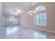 Spacious living room featuring large windows, plantation shutters, neutral paint colors, and tile flooring at 15809 S 31St St, Phoenix, AZ 85048