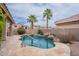 Backyard pool with rock waterfall, mature trees and desert landscaping at 15809 S 31St St, Phoenix, AZ 85048