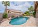 Backyard pool with rock waterfall, mature trees and desert landscaping at 15809 S 31St St, Phoenix, AZ 85048