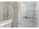 Close-up of marble-looking shower with glass door, multiple shower heads and grab bars at 15809 S 31St St, Phoenix, AZ 85048