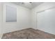 Neutral bedroom featuring plush carpeting, modern closet, and window with bright natural light at 15941 N 171St Ln, Surprise, AZ 85388