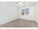 Bright, carpeted bedroom with a ceiling fan and natural light from a window at 15941 N 171St Ln, Surprise, AZ 85388