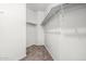 Walk-in closet features carpet flooring, white walls, and shelving for storage at 15941 N 171St Ln, Surprise, AZ 85388