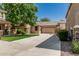 Charming single-story home features stucco siding, a tiled roof, and a spacious driveway leading to an attached garage at 15941 N 171St Ln, Surprise, AZ 85388