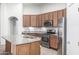 Spacious kitchen features an island, granite countertops, stainless steel appliances, and wood cabinets at 15941 N 171St Ln, Surprise, AZ 85388