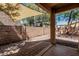 Covered patio with brick flooring, shade sail, and view of the backyard at 15941 N 171St Ln, Surprise, AZ 85388