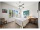 Bedroom with a ceiling fan, shuttered windows, and quilt bedspread provides a cozy retreat at 17 W Vernon Ave # 31, Phoenix, AZ 85003