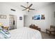 Bedroom with ceiling fan, desk, and bed features access to the en-suite bathroom at 17 W Vernon Ave # 31, Phoenix, AZ 85003