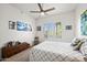 Bright bedroom with a ceiling fan, shuttered windows, and light colored quilt at 17 W Vernon Ave # 31, Phoenix, AZ 85003
