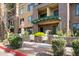 Brick condos with green trim, landscaping, and covered patios at 17 W Vernon Ave # 31, Phoenix, AZ 85003