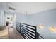 Hallway with metal railings, wood look flooring, pendant lighting, and light blue walls at 17 W Vernon Ave # 31, Phoenix, AZ 85003