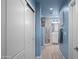 Hallway view leads to a bathroom with white cabinets, modern fixtures, and tile flooring at 17 W Vernon Ave # 31, Phoenix, AZ 85003