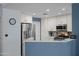 Kitchen area with white cabinets, stainless steel appliances, and modern backsplash at 17 W Vernon Ave # 31, Phoenix, AZ 85003