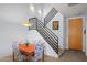Living room dining area features stairs with metal railing and modern light fixtures at 17 W Vernon Ave # 31, Phoenix, AZ 85003